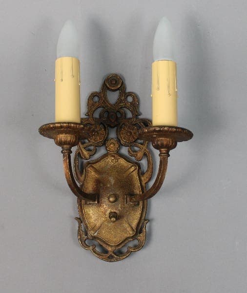 Ornate two-candle wall sconce in vintage style.