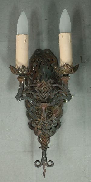 Antique wall sconce with two candle holders.
