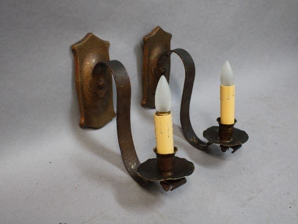 Wall-mounted candle holders with two lights.
