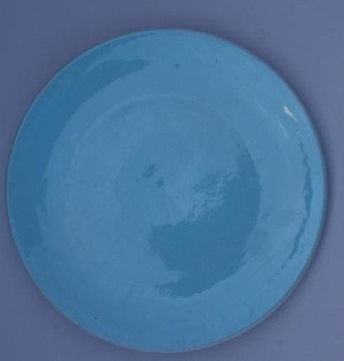 Blue ceramic plate on a gray background.