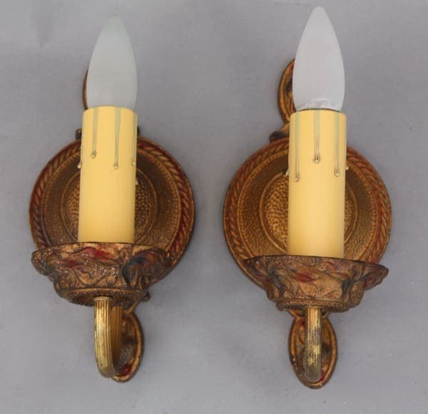 Gold wall sconces with candle-like bulbs.