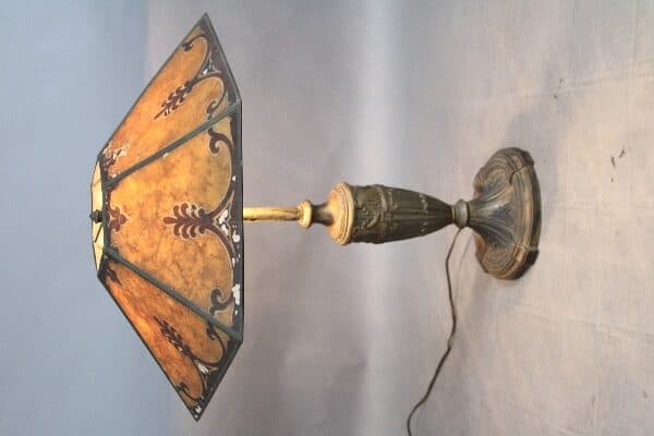 Antique table lamp with decorative lampshade.