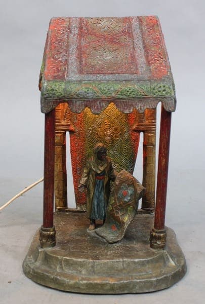Antique figurine lamp with colorful canopy.