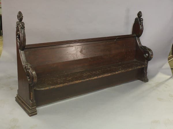 Ornate wooden church pew with carvings.