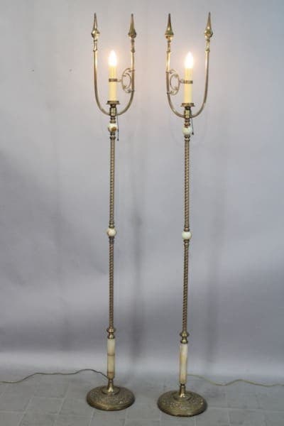 Two ornate standing lamps with lit bulbs.