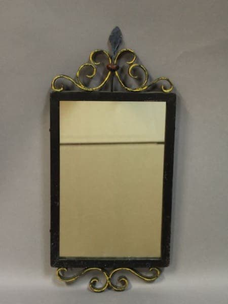 Ornate wall mirror with decorative frame.