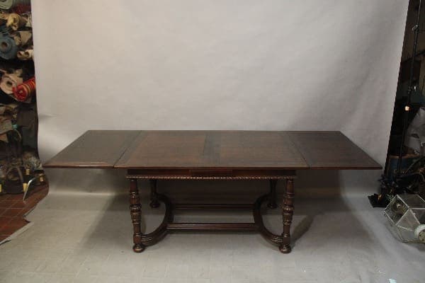 Dark wooden antique extendable dining table.