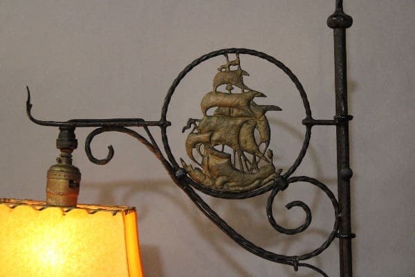 Ornate metal lamp with ship design.