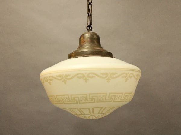 Vintage pendant light with ornate glass shade.