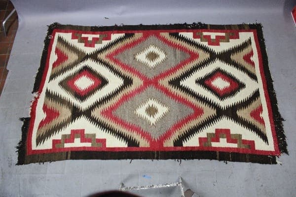 Geometric patterned rug with red and brown.