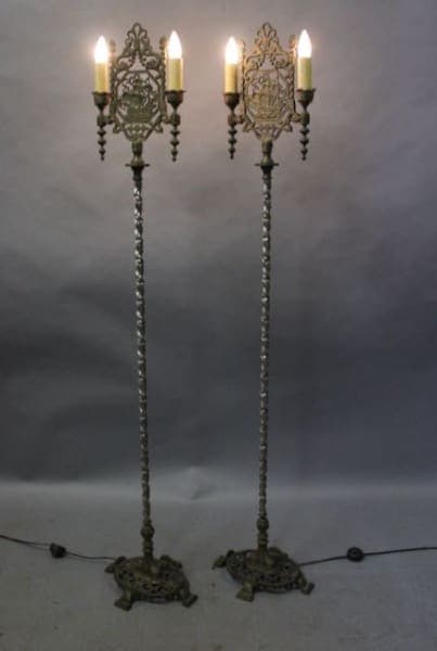 Two ornate vintage floor lamps with lights.