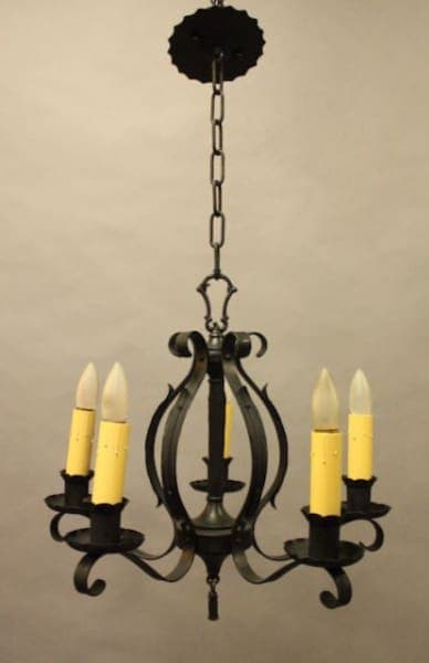Black wrought iron candle chandelier hanging.