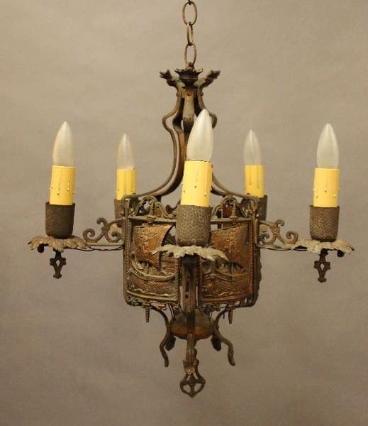 Vintage metal chandelier with five candle lights.