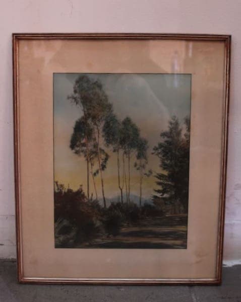 Framed landscape painting with tall trees.