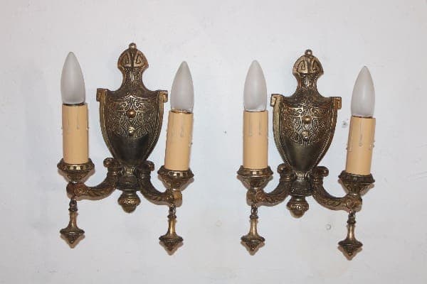 Vintage bronze wall sconces with candle bulbs.