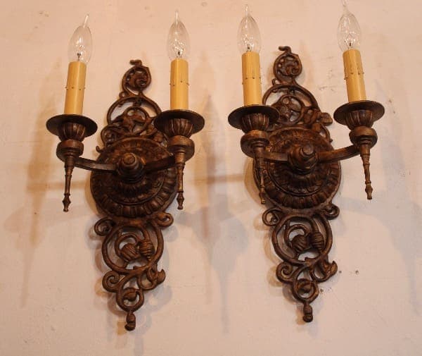Ornate vintage wall sconces with candles.