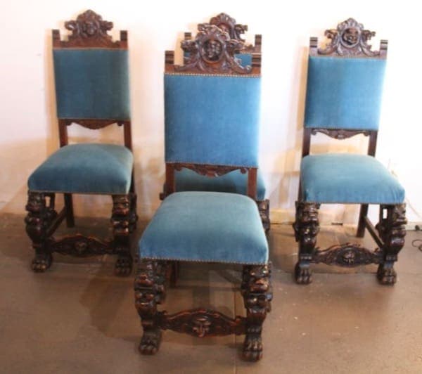 Three ornate blue upholstered wooden chairs.