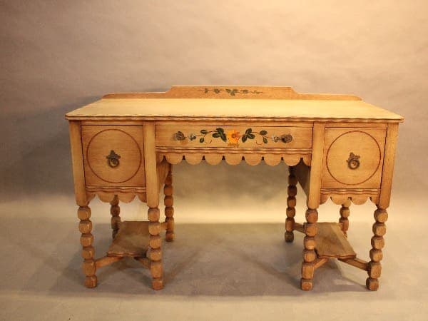 Vintage wooden desk with floral details.