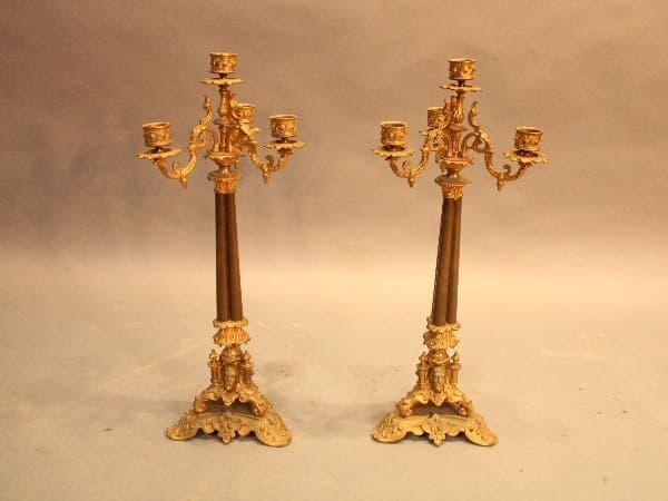 Two ornate gold and bronze candelabras.