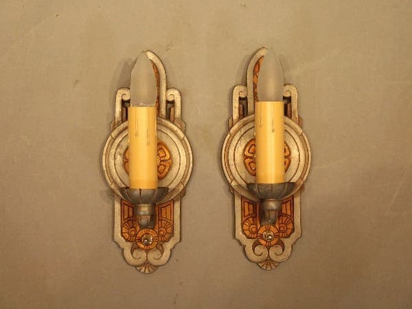 Two vintage wall sconces with candles.
