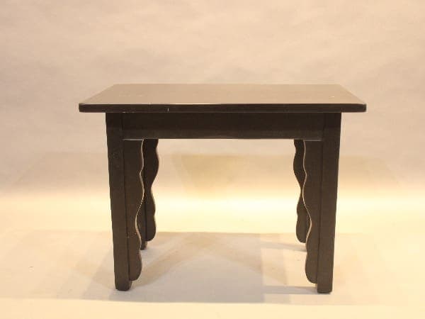 Wooden table with decorative curved legs.