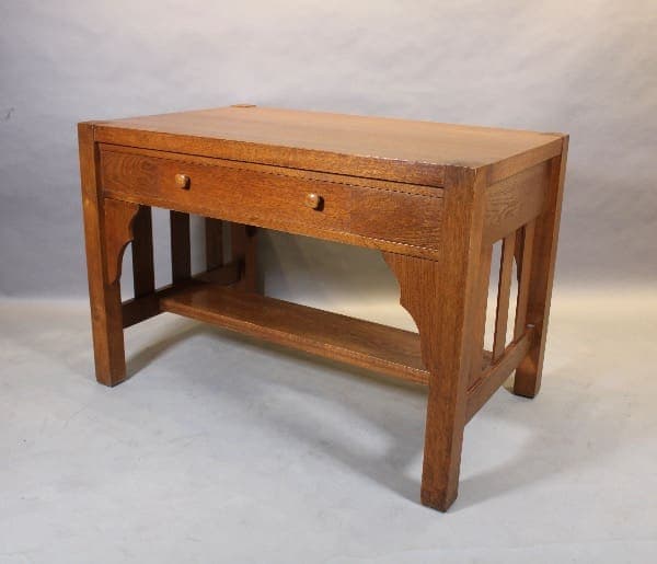 Wooden desk with a drawer and shelf.
