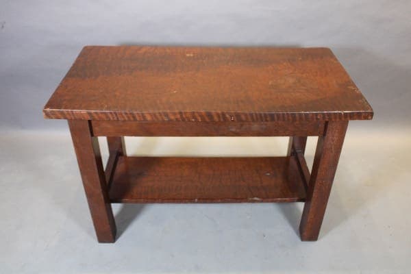 Wooden table with lower shelf.