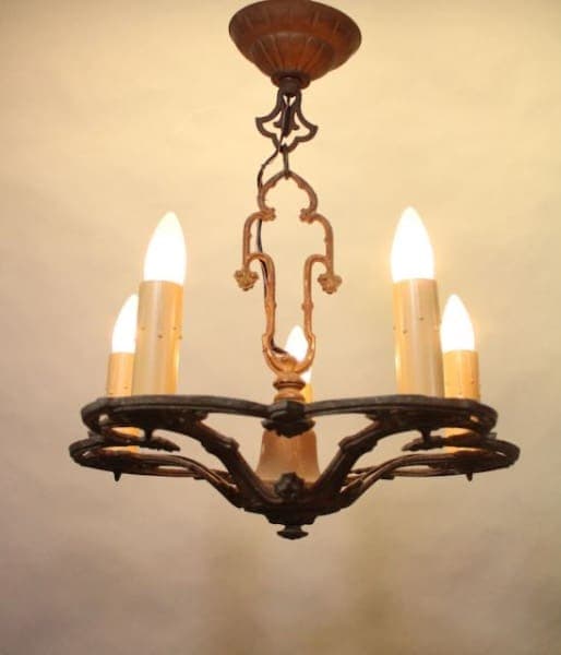 Vintage chandelier with glowing candle bulbs.