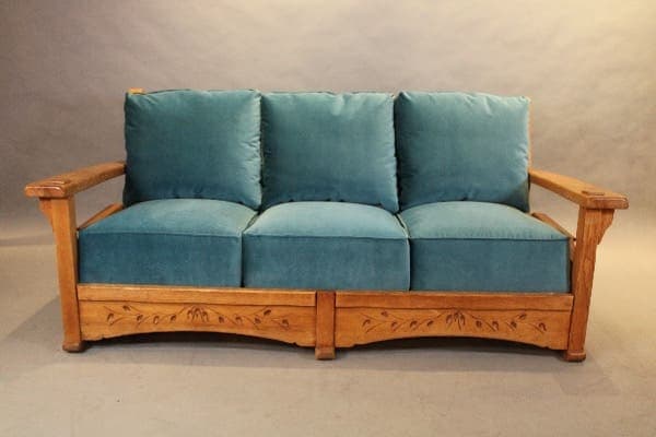 Wooden sofa with blue cushions.