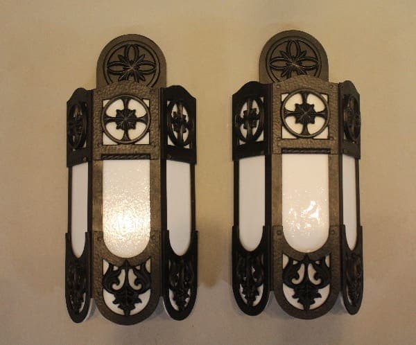 Two decorative wall sconces with ornate design.