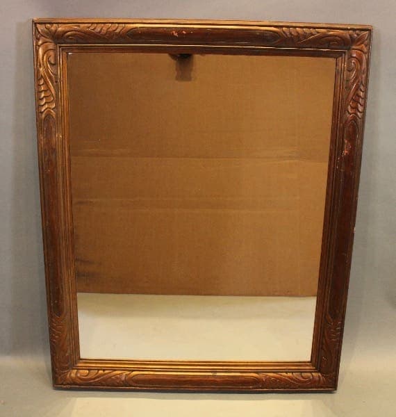 Ornate wooden framed rectangular mirror.