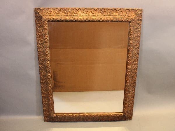 Ornate gold frame with reflective surface.