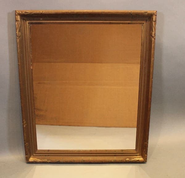 Rectangular vintage mirror with ornate frame.