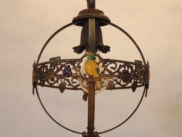 Ornate antique lamp with bird design.