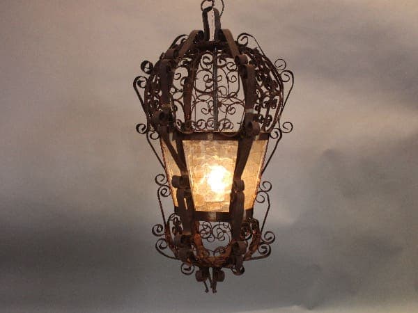 Ornate hanging lantern with intricate metalwork design.