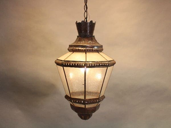 Vintage hanging lantern with illuminated bulbs.