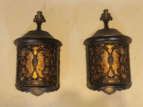 Two ornate vintage wall sconces with scrollwork.