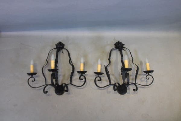Two ornate black metal wall sconces.