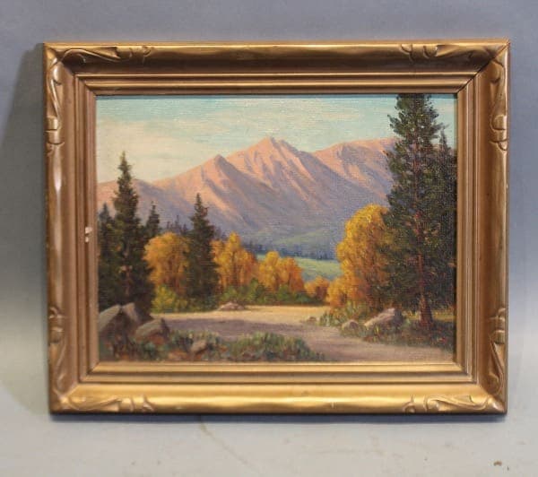 Framed landscape painting with mountains and trees.
