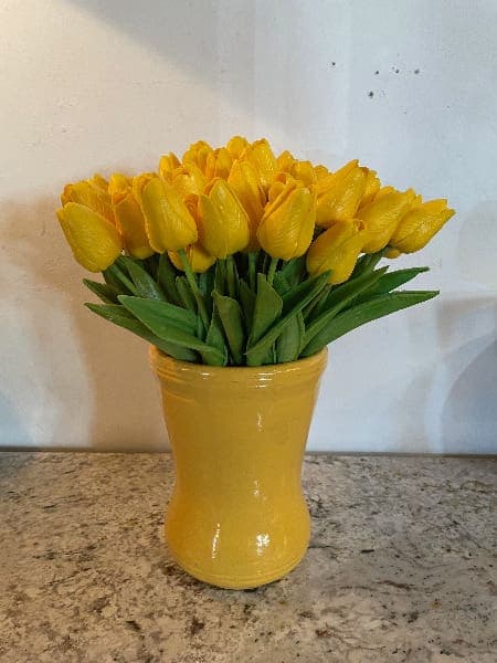 Yellow tulips in a matching vase.