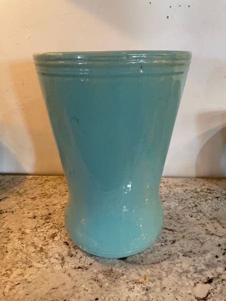 Blue ceramic vase on granite countertop.