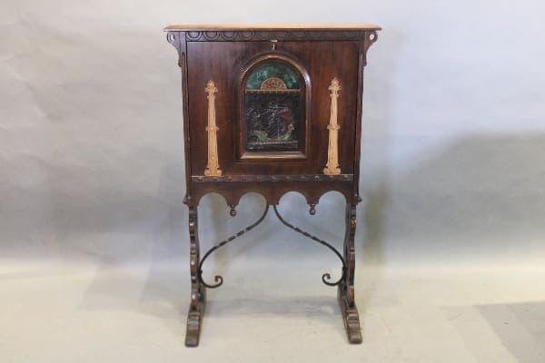 Antique wooden cabinet with ornate metal legs.