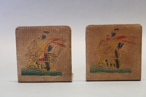 Embossed ship design bookends on display.