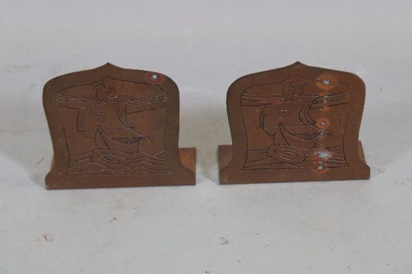 Two decorative wooden bookends with carvings.
