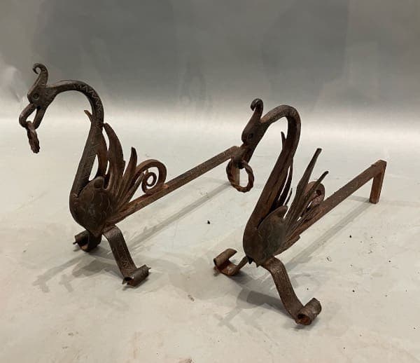 Ornate dragon-shaped metal fireplace andirons.