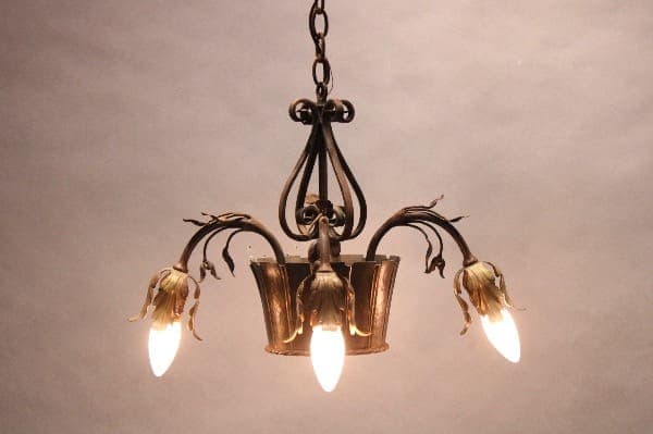 Vintage chandelier with floral design lights.