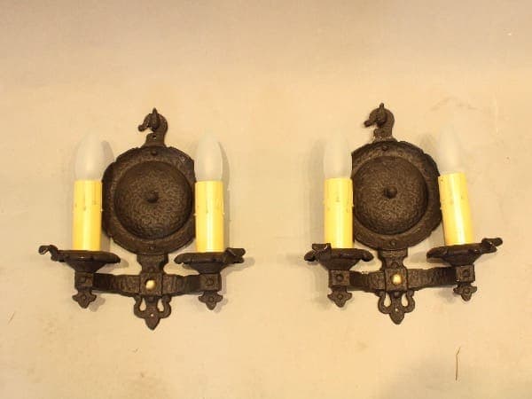 Antique wall sconces with candle bulbs.