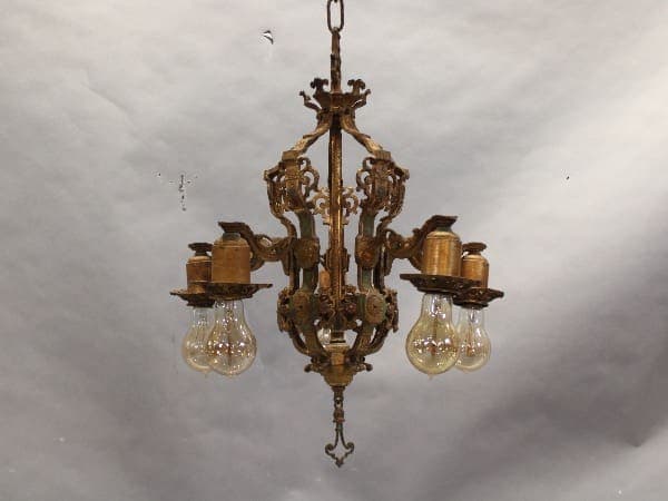 Ornate vintage chandelier with exposed bulbs.