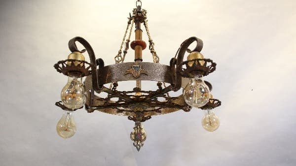 Vintage wrought iron chandelier with bulbs.
