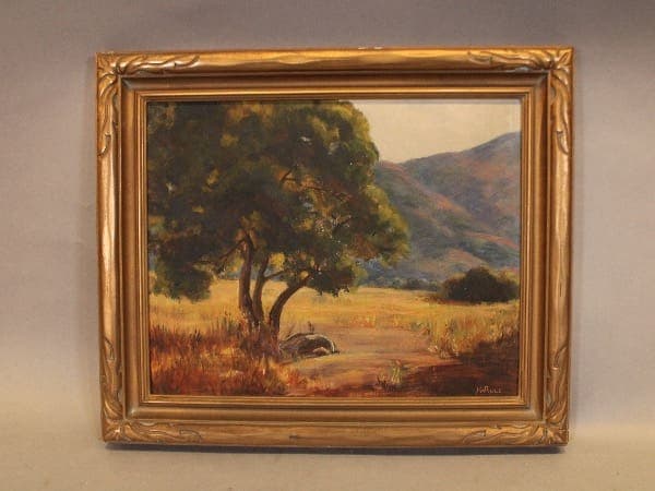 Framed landscape painting with tree and hills.